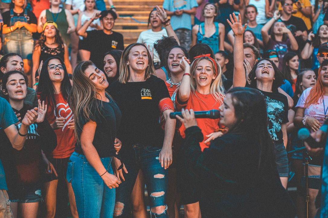 Young people singing and celebrating together at a live event